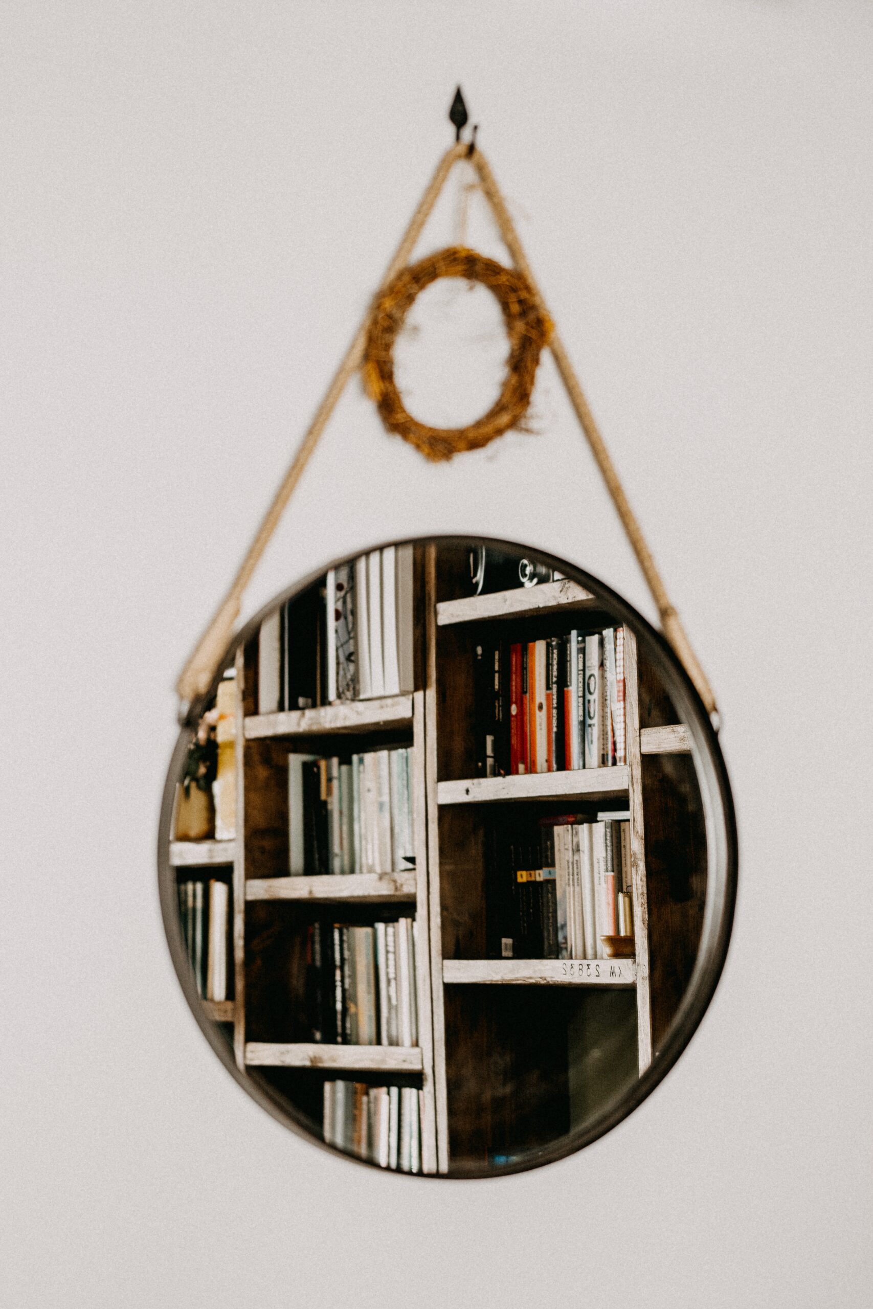 hanging mirror reflecting bookcases
